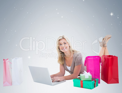 Happy blonde shopping online with laptop