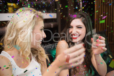 Composite image of happy friends having a drink together