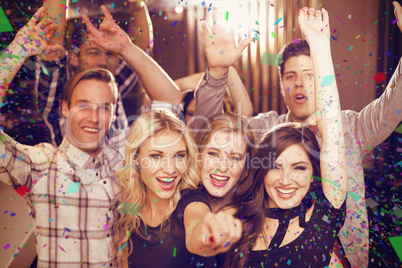 Composite image of stylish friends dancing and smiling