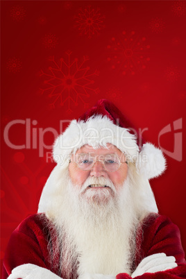 Composite image of santa smiles with folded arms