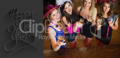 Composite image of happy gorgeous women holding flutes of champa