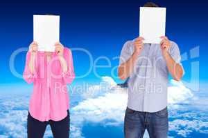 Composite image of people holding sheets over faces