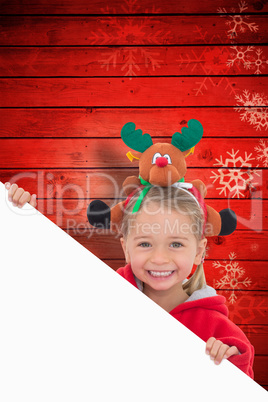 Composite image of festive little girl showing poster