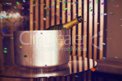 Composite image of champagne in an ice bucket