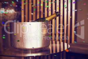 Composite image of champagne in an ice bucket