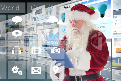 Composite image of santa uses a tablet pc