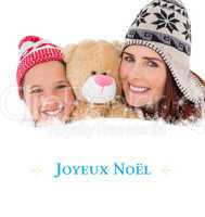 Composite image of mother and daughter holding teddy bear