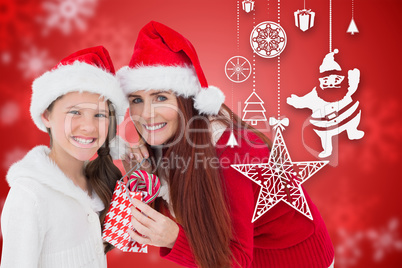 Composite image of mother and daughter with gift