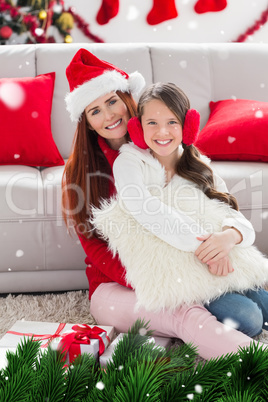 Composite image of festive mother and daughter smiling at camera