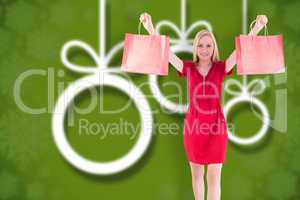 Composite image of pretty blonde in red dress holding shopping b