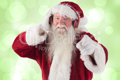 Composite image of santa is listening some music