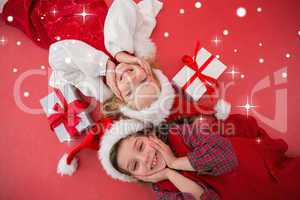 Composite image of festive little girls smiling at camera with g