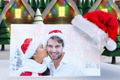 Composite image of festive young couple holding gift