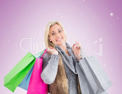 Blonde in winter clothes holding shopping bags