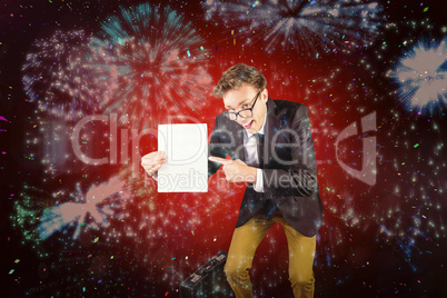 Composite image of young geeky businessman holding page