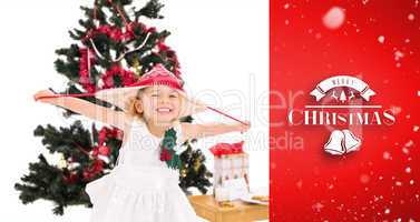 Composite image of festive little girl smiling at camera