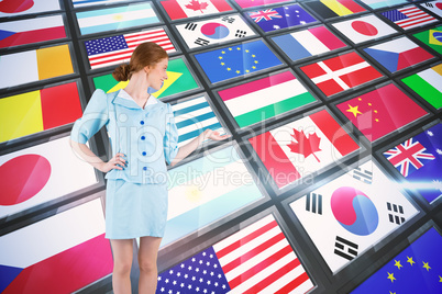 Composite image of pretty air hostess presenting with hand