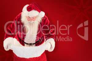 Composite image of santa looks in his bag