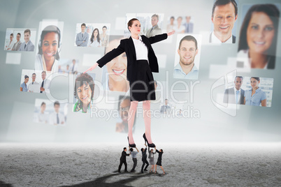 Composite image of business people supporting boss