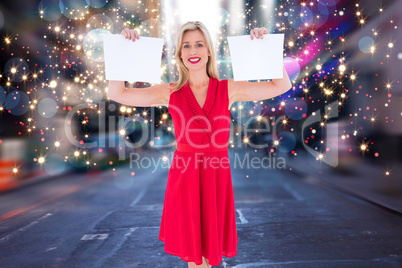 Composite image of stylish blonde in red dress holding pages