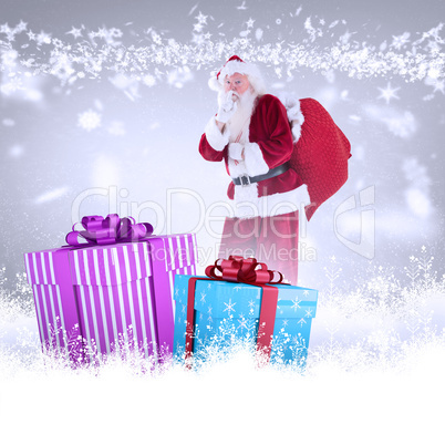 Composite image of santa asking for quiet with bag