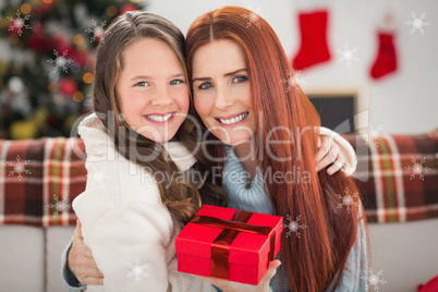 Composite image of daughter giving her mother a christmas presen