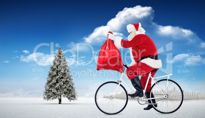 Composite image of santa cycling and holding his sack