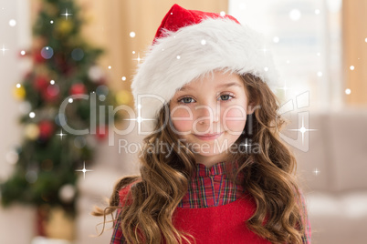 Composite image of festive little girl smiling at camera