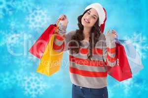 Composite image of cheerful brunette holding shopping bags