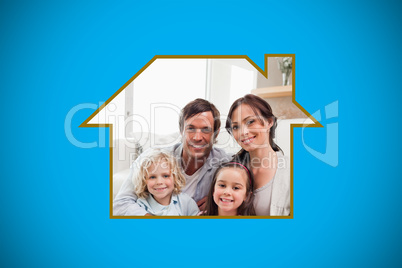 Composite image of portrait of a family relaxing in their living