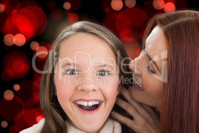Composite image of mother and daughter telling secrets