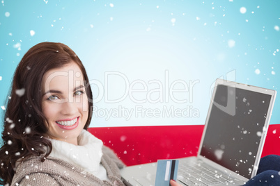 Composite image of brunette shopping online