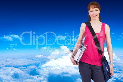 Composite image of woman holding her school notebooks
