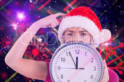 Composite image of festive blonde showing a clock