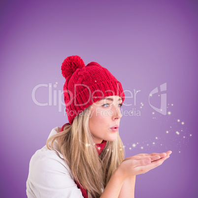 Composite image of happy blonde blowing over hands Composite image of happy blonde blowing over hands