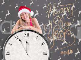 Composite image of festive fit blonde posing with exercise ball