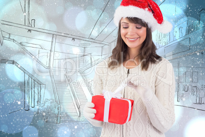 Composite image of festive brunette in santa hat opening a gift