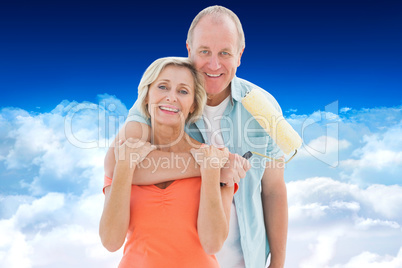 Composite image of happy older couple holding paint roller