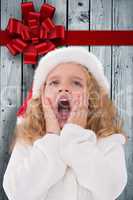 Composite image of festive little girl with hands on face