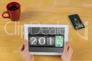 Composite image of businesswoman using tablet at desk