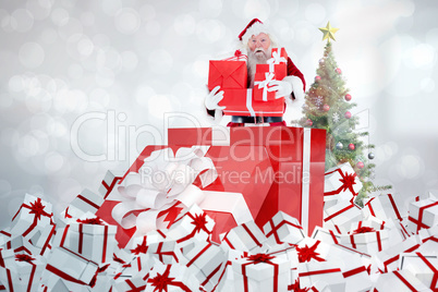 Composite image of santa standing in large gift