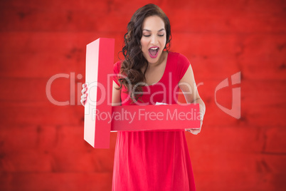 Composite image of brunette thinking and holding shopping bag