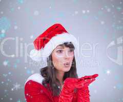 Composite image of pretty brunette in santa outfit blowing over