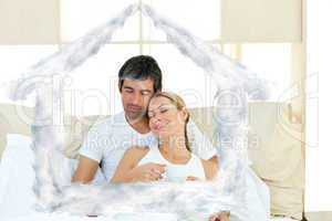 Composite image of positive couple drinking coffee lying in the