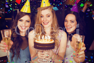 Composite image of attractive friends celebrating a birthday