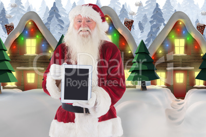 Composite image of santa presents a tablet pc