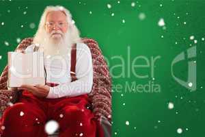 Composite image of father christmas showing a book