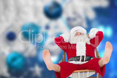 Composite image of relaxed santa stiting on deckchair