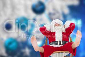 Composite image of relaxed santa stiting on deckchair