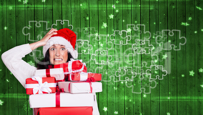 Composite image of shocked woman with christmas presents